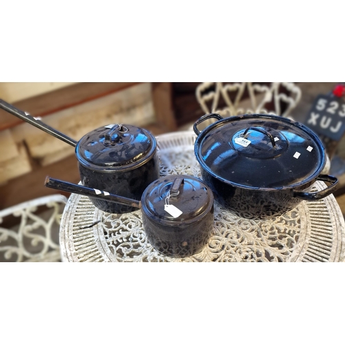 550 - Two similar vintage enamel lidded saucepans together with a larger circular two handled lidded pan. ... 