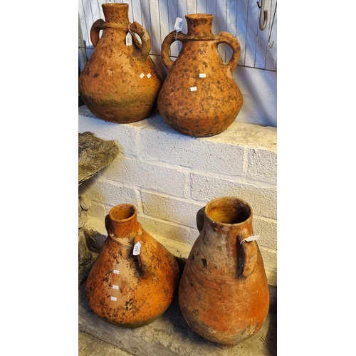 559 - Collection of similar two handle terracotta baluster weathered vessels. The tallest 60cm high approx... 