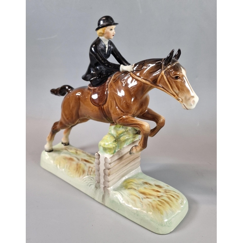 6 - Beswick huntswoman on bay horse, jumping a fence.  (B.P. 21% + VAT)