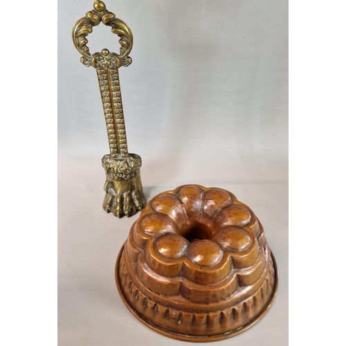 61 - Copper finish jelly mold (23cm diameter approx.) together with a brass paw shaped doorstop with foli... 