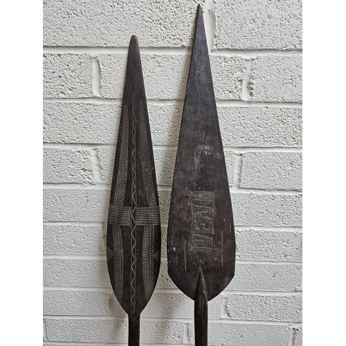 191 - Two South Seas design ceremonial paddles with chip carved decoration. 150cm long approx. (2)  (B.P. ... 