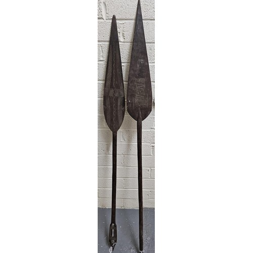 191 - Two South Seas design ceremonial paddles with chip carved decoration. 150cm long approx. (2)  (B.P. ... 