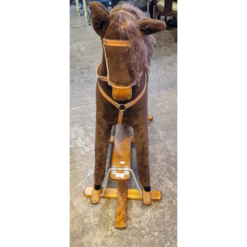 590 - Mid 20th century child's upholstered rocking horse on swing frame base. Bearing label to leather sad... 