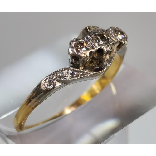 262 - 18ct gold and platinum three stone diamond twist shank ring. 2.6g approx. Size P. (B.P. 21% + VAT)