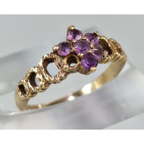 266 - 9ct gold and purple stone flowerhead ring (missing one stone). 2.3g approx. Size J1/2. (B.P. 21% + V... 