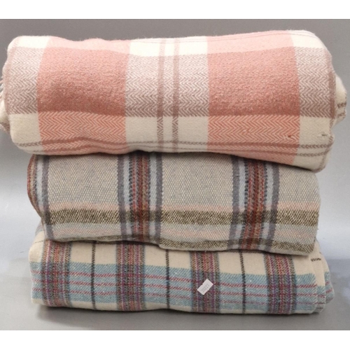 112 - A blue and cream checked blanket together with a coral and cream blanket and a grey and blue checked... 