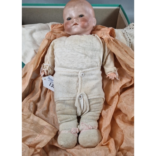 136 - Armand and Marseille German bisque headed doll in appearing original clothing with rolling glass eye... 