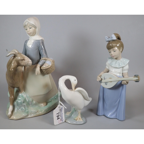 194 - Two Lladro Spanish porcelain figure groups, one of a young girl with goat together with a Nao porcel... 