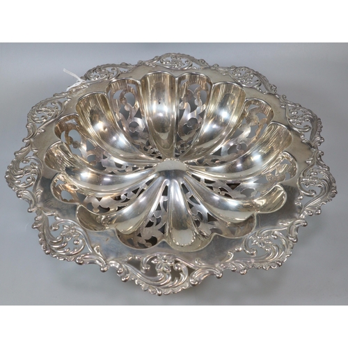 233 - Edward VII silver basket/bowl, with ornate floral and foliate pierced rim, raised on four ball feet,... 