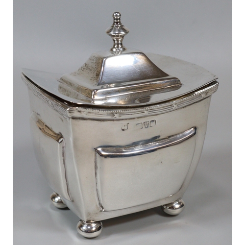 238 - Silver boat shaped sucrier, the hinged lid above and raised on four ball feet, indistinct hallmarks ... 