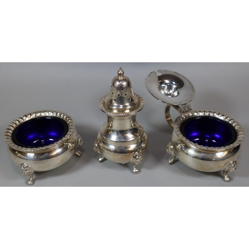 240 - Silver three piece condiment set comprising: pepperette, salt and mustard, with blue glass liners, B... 