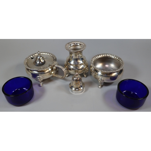 240 - Silver three piece condiment set comprising: pepperette, salt and mustard, with blue glass liners, B... 