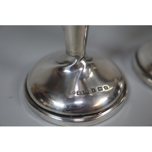 241 - Pair of George V silver vase shaped candlesticks on loaded bases, by Oldfield Ltd, Birmingham 1927. ... 