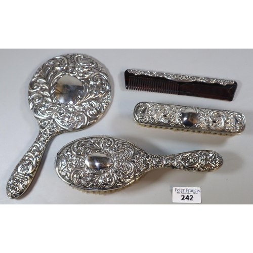 242 - 20th century four piece vanity set comprising hand mirror, two brushes and a comb, by Broadway & Co ... 