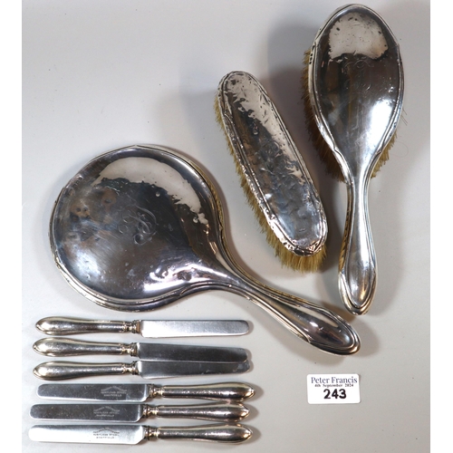 243 - Three piece silver ladies' vanity set comprising hand mirror and two brushes, George V period, Birmi... 