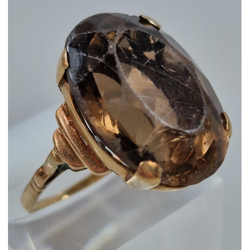 255 - Yellow metal and smokey quartz dress ring with heart pierced decoration. 6.7g approx. Size L.  (B.P.... 