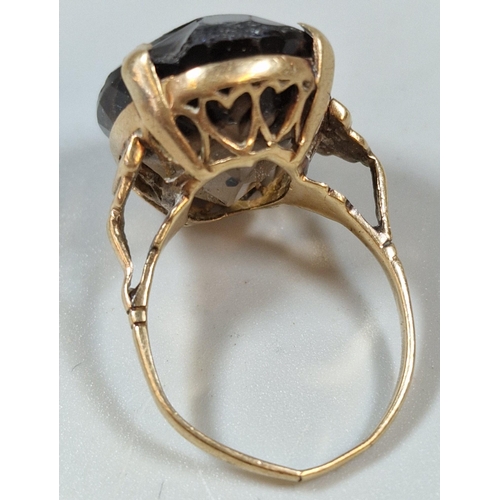 255 - Yellow metal and smokey quartz dress ring with heart pierced decoration. 6.7g approx. Size L.  (B.P.... 