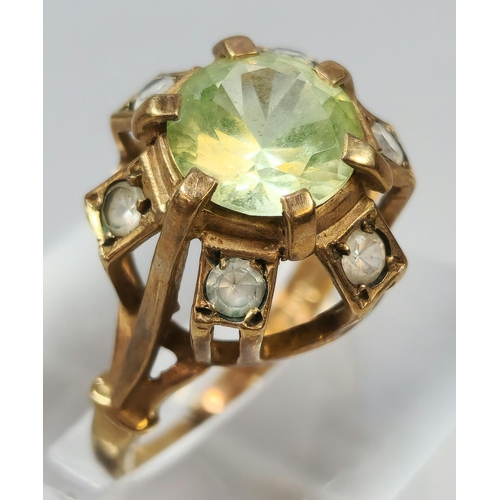 263 - 9ct gold multi cluster clear stone ring with central green stone. 3.5g approx. Size L.  (B.P. 21% + ... 