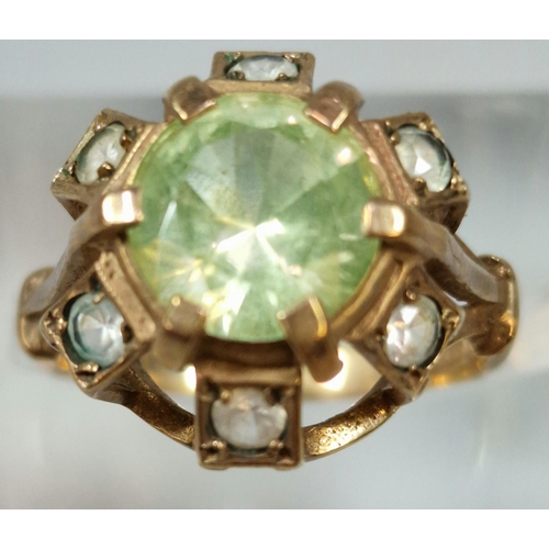 263 - 9ct gold multi cluster clear stone ring with central green stone. 3.5g approx. Size L.  (B.P. 21% + ... 