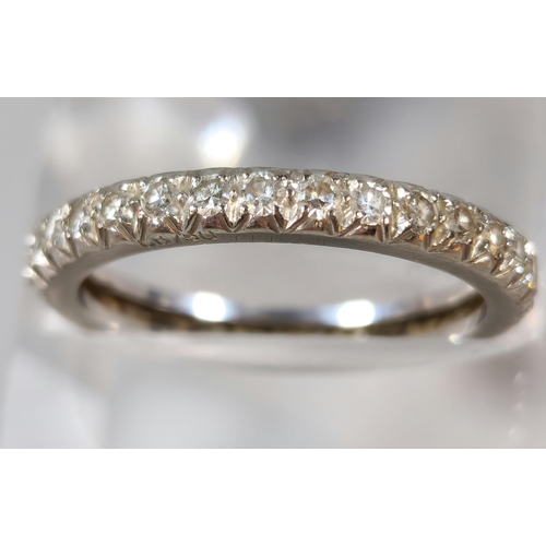 282 - White metal and diamond full eternity ring. Unmarked. 2.6g approx. Size M. (B.P. 21% + VAT)