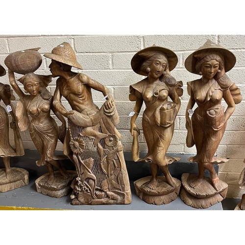 456 - Large collection of  Balinese carved wood nude and semi-nude women, mainly at work with baskets and ... 