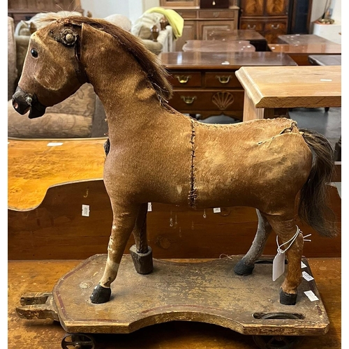 472 - Victorian child's pull along toy horse on painted pine stand and wheels. (B.P. 21% + VAT)