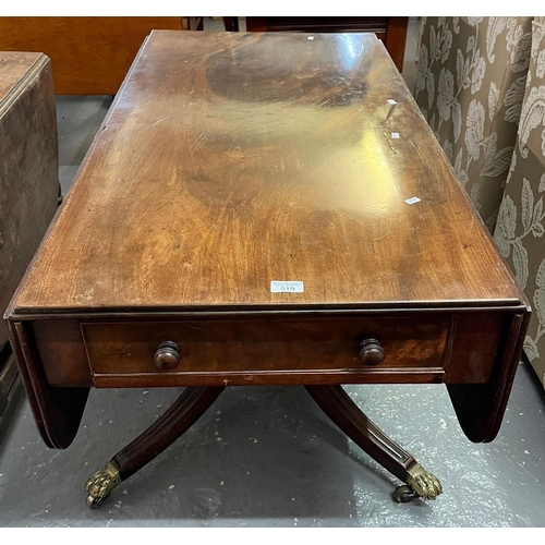 519 - Regency period mahogany sofa table on brass paw feet and casters. (B.P. 21% + VAT)