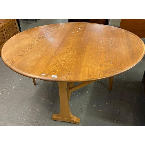 523 - Mid century Ercol Elm Windsor drop leaf table. 142cm diameter x 72cm high approx. (B.P. 21% + VAT)