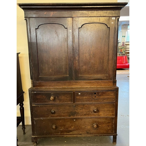 530 - Early 19th century oak two stage press cupboard, the moulded cornice above two blind panelled doors,... 