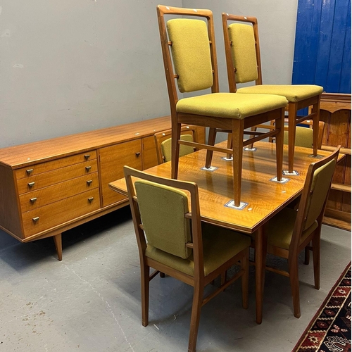 534 - Alfred Cox, a mid century teak dining room suite comprising sideboard, dining table and set of six c... 