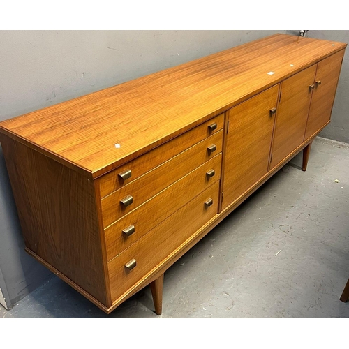 534 - Alfred Cox, a mid century teak dining room suite comprising sideboard, dining table and set of six c... 