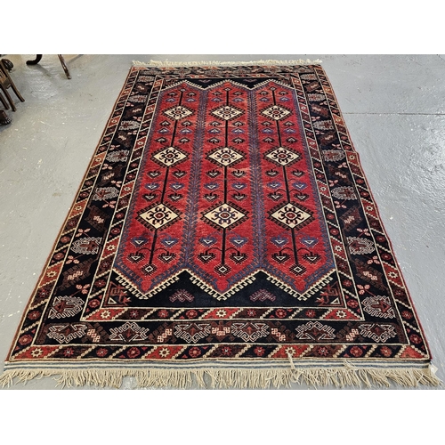 584 - Middle Eastern design red ground carpet with tarantula panels. 295cm x 198cm approx. (B.P. 21% + VAT... 