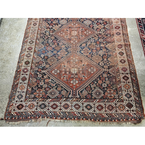 585 - Middle Eastern red and blue ground rug with foliate and animal decoration, tarantula panels etc. 285... 