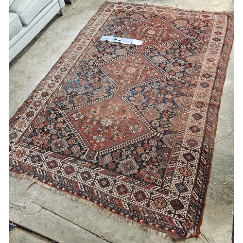 585 - Middle Eastern red and blue ground rug with foliate and animal decoration, tarantula panels etc. 285... 