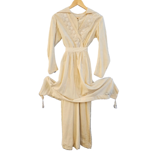 586 - circa 1960s long trained wedding gown of ivory sateen. Cuffs and front panel with self-coloured gilt... 