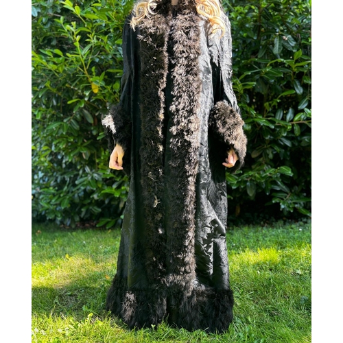 590 - Victorian full length black damask coat with feathered trim, broad low set sleeves and inverted plea... 