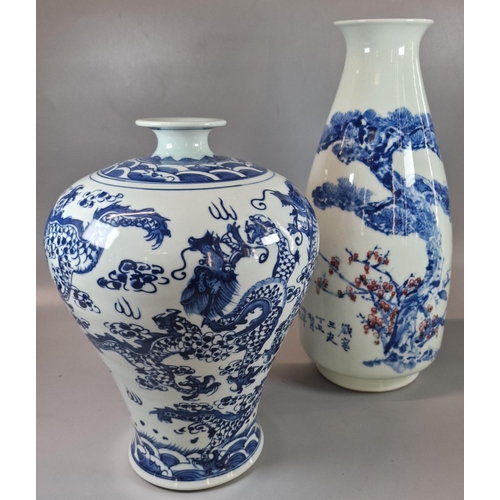 67 - Two Oriental porcelain blue and white vases to include one with copper red highlights in the motif a... 