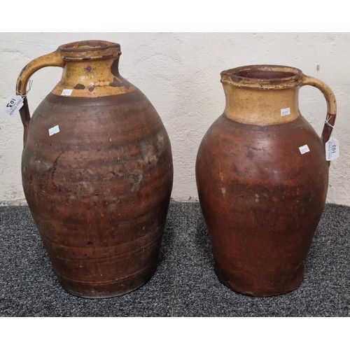 103 - Two similar terracotta single handled and glazed baluster jugs. The taller 48cm high approx. (2) (B.... 