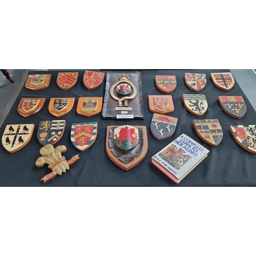 115 - An interesting and decorative collection of Welsh wooden armorials including: county badges, two Wel... 