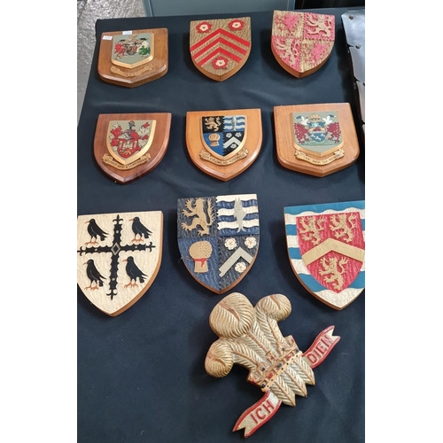 115 - An interesting and decorative collection of Welsh wooden armorials including: county badges, two Wel... 