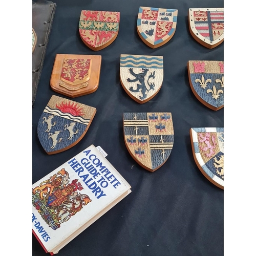 115 - An interesting and decorative collection of Welsh wooden armorials including: county badges, two Wel... 