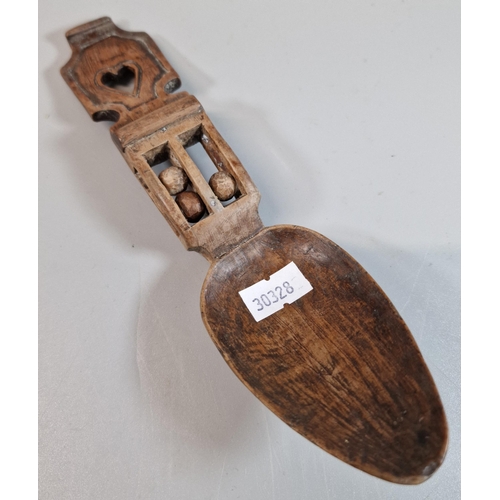 140 - 19th century Welsh Love spoon with carved heart decoration with three ball in a cage above the bowl.... 