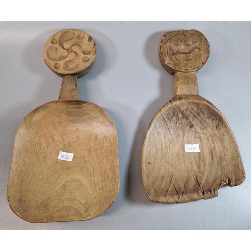 142 - Two similar 19th century Welsh sycamore scoops with double sided butter stamps to the handles of a c... 