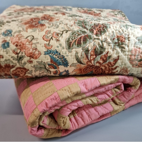 165 - Cream, green and rust floral Welsh quilt together with a pink, gold check quilt. (2) (B.P. 21% + VAT... 