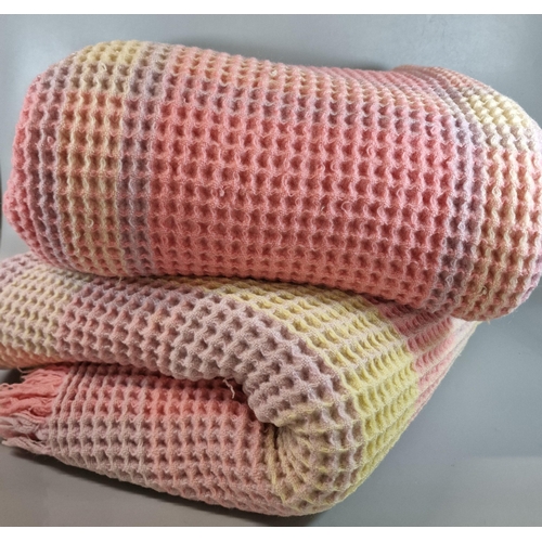 167 - Vintage honeycomb blanket in tones of pink, lilac and yellow. (B.P. 21% + VAT)