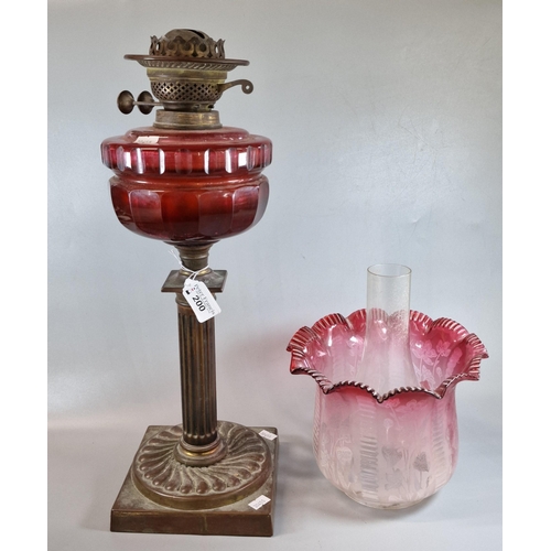 200 - Early 20th century double oil burner lamp, having frosted cranberry shade with organic decoration ab... 