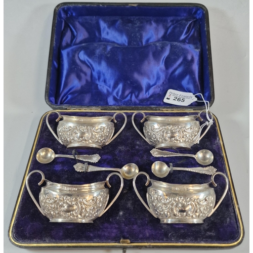 265 - Set of four late Victorian silver repoussé boat shaped salts with four salt spoons in original box, ... 