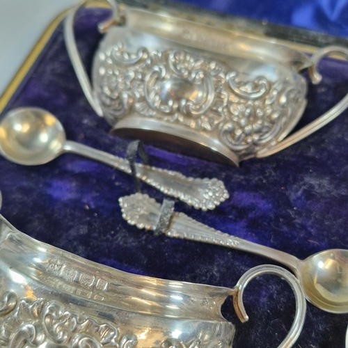 265 - Set of four late Victorian silver repoussé boat shaped salts with four salt spoons in original box, ... 