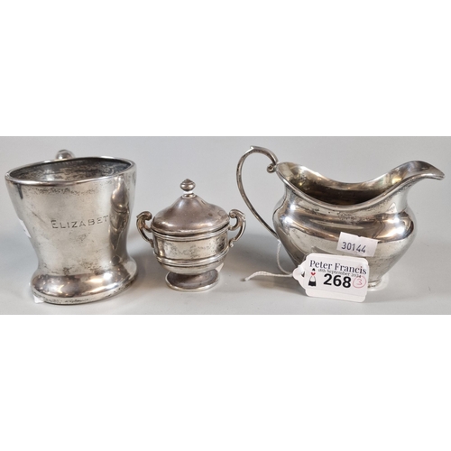 268 - Collection of silver to include: helmet shaped milk jug, single handled mug/cup and two handled pres... 