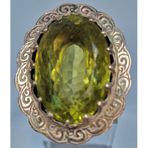 311 - 9ct gold green stone dress ring of large oval form. 21.5g approx. Size L1/2. (B.P. 21% + VAT)